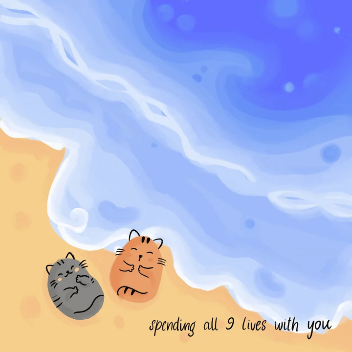 Two cats resting by the edge of a blue sea.