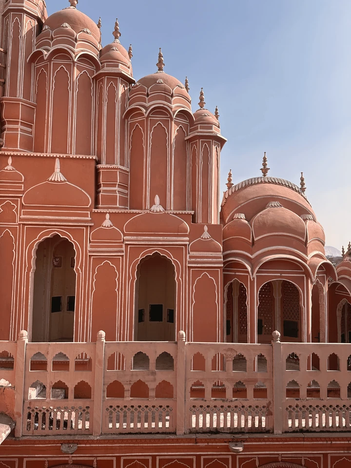 Ornate pink architecture against a pale blue sky.