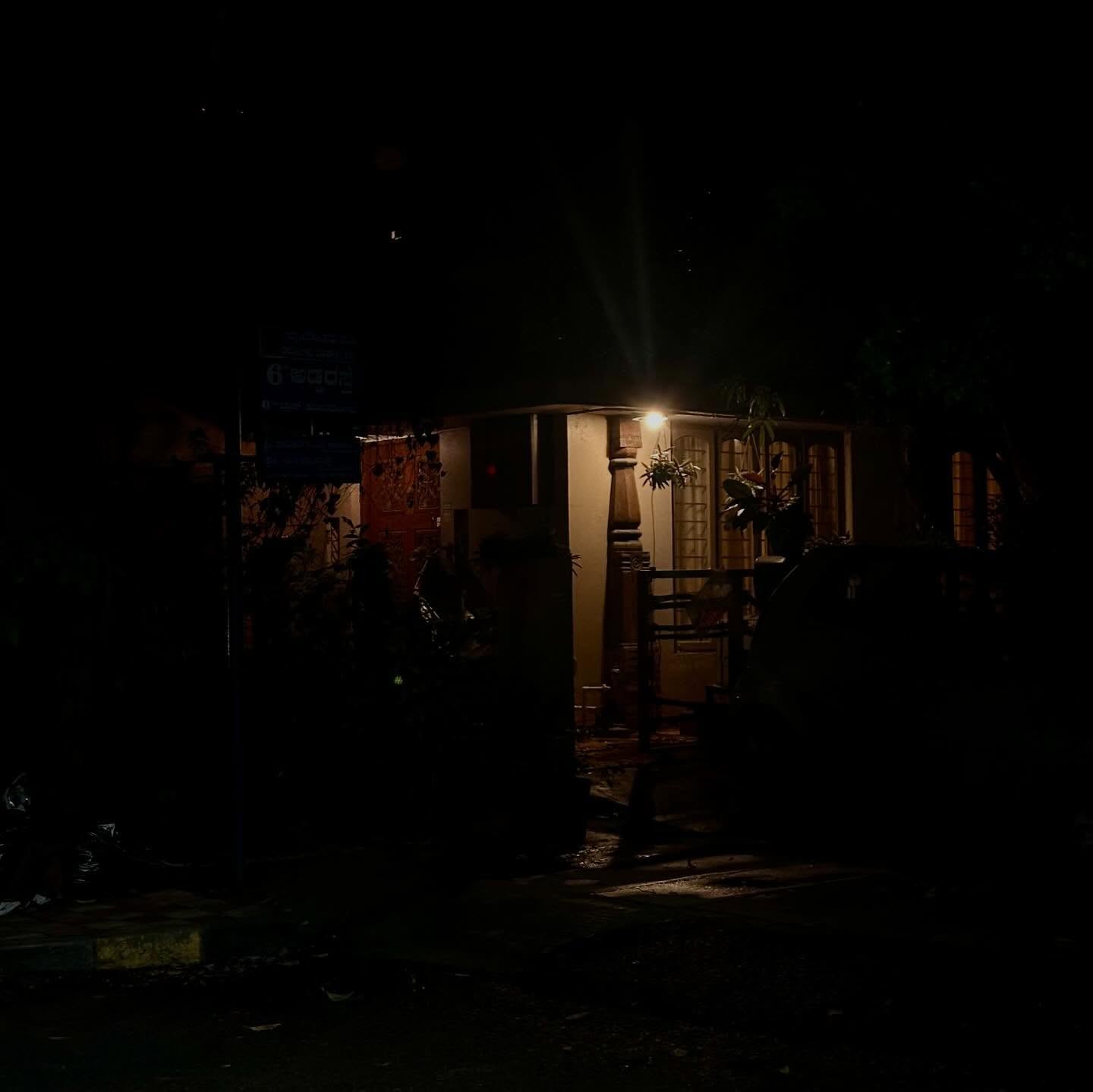 A softly lit doorway and window in a building at night.
